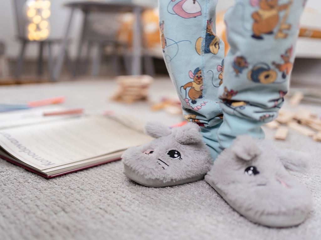 Barn tar på sig stora inneskor i nybyggt hus